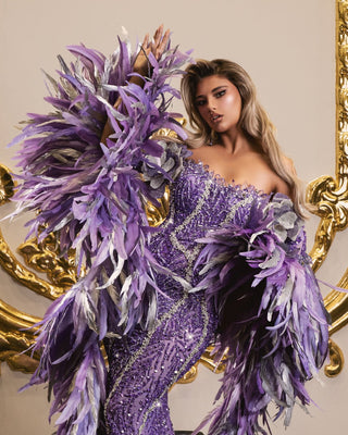 Long purple dress adorned with crystals and feathers