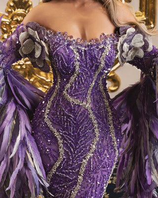 Detailed close-up of light purple dress embellished with purple and silver crystals