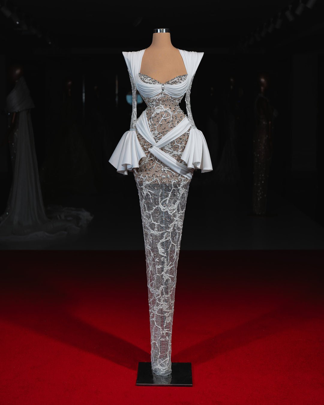 A fitted wedding dress with a sweetheart neckline, shimmer, and elegant draping.