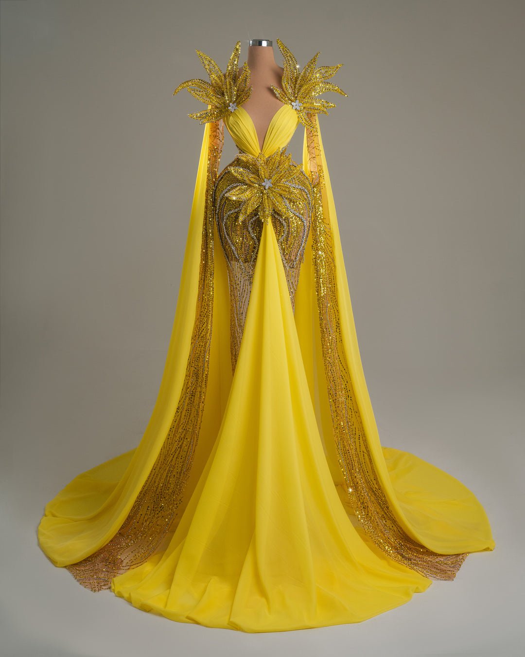 Yellow dress with crystal accents, floral details, and shoulder cape.