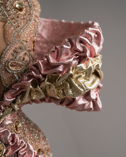 Artistic mini with pink ruffles and a gold liquid-sheen skirt.