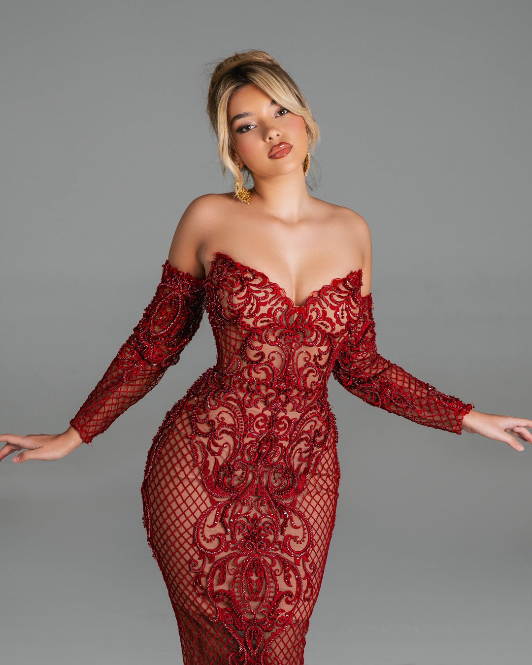 Luxury handmade red dress with sleek silhouette.