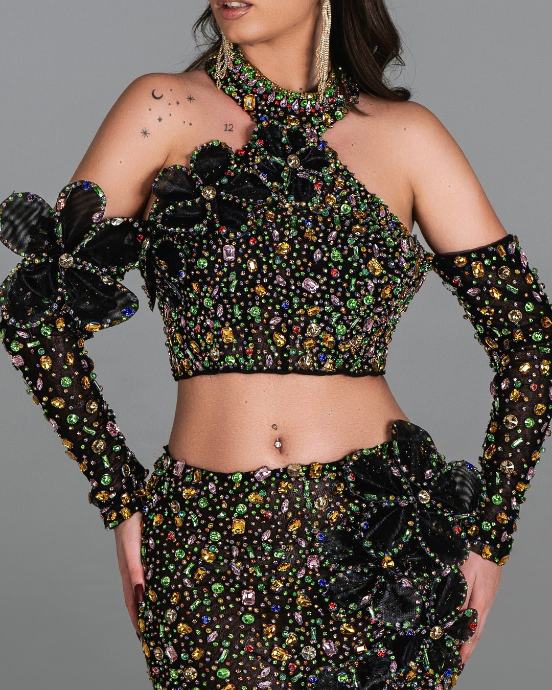 Sophisticated black dress with shimmering floral patterns and bold 3D appliqués.