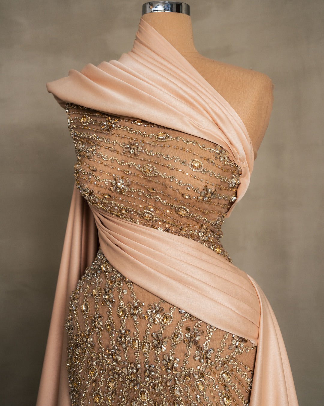 Close-up of champagne dress lace detailing with sparkling stones and crystals