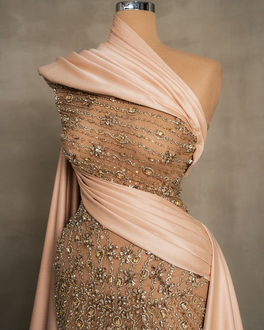 Close-up of champagne dress lace detailing with sparkling stones and crystals