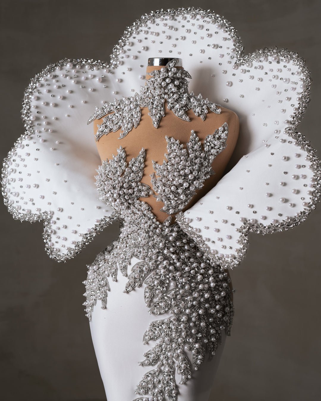 Close-up of bridal dress neckline with crystals and pearls