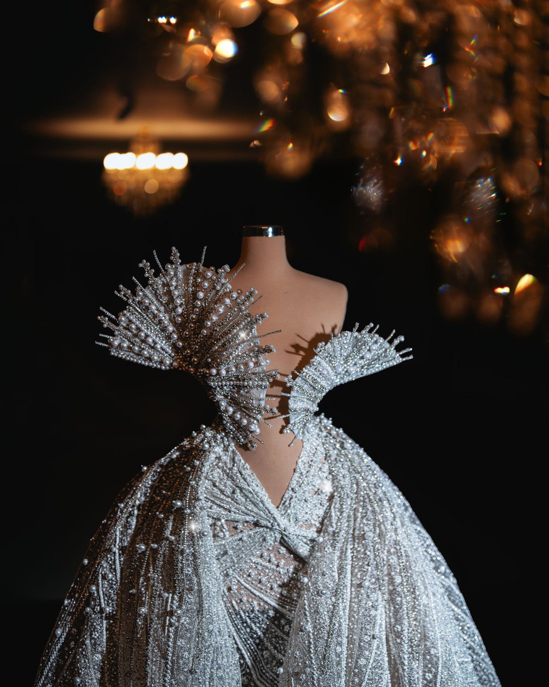 Elegant bridal gown with sparkling bead embellishments and a detachable overskirt, exuding timeless sophistication.