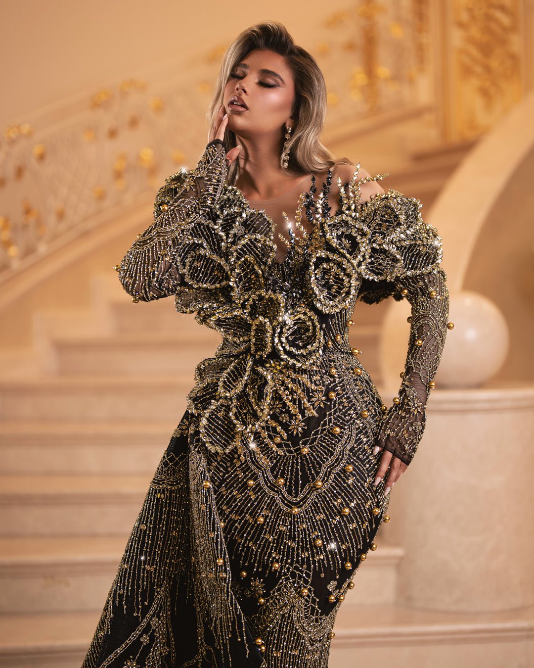 Luxurious lace black dress adorned with sparkling gold details and feather accents