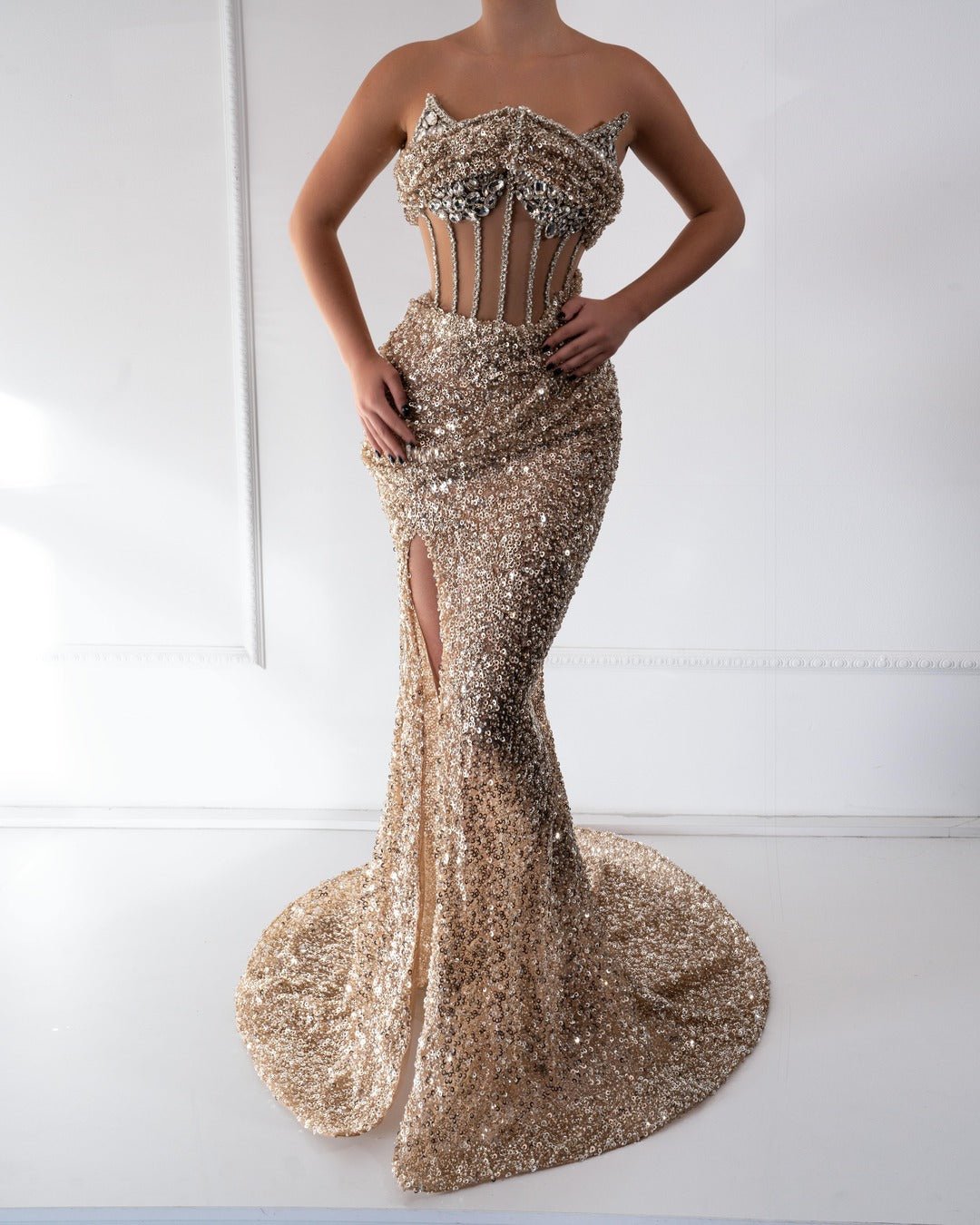 
Handcrafted gold dress with crystals, beads, and a deep slit for elegant allure.