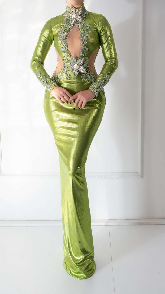 A light green dress with floral embroidery, crystals, and an open chest design.
