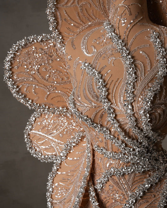 Intricate crystal embellishments on a one shoulder dress with crystals