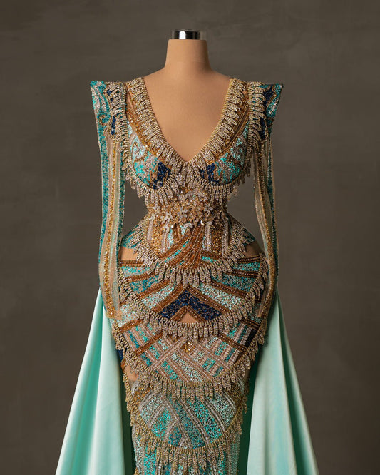Elegant long aqua dress embellished with beads and stones with V-neck and overskirt