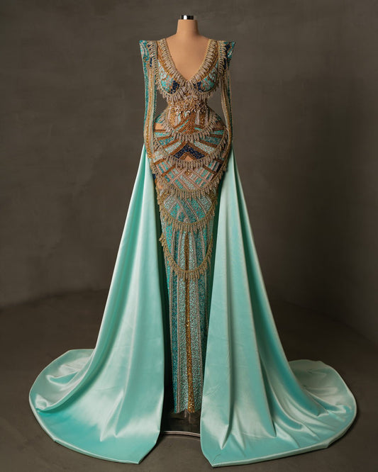 Luxury aqua dress with long sleeves, V-neck, and satin overskirt embellished with beads and stones