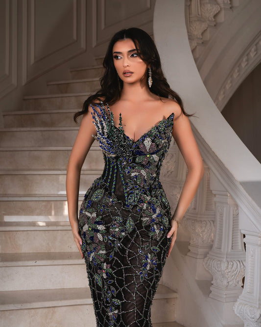 Crystal-embellished deep blue and emerald gown with a figure-hugging silhouette.