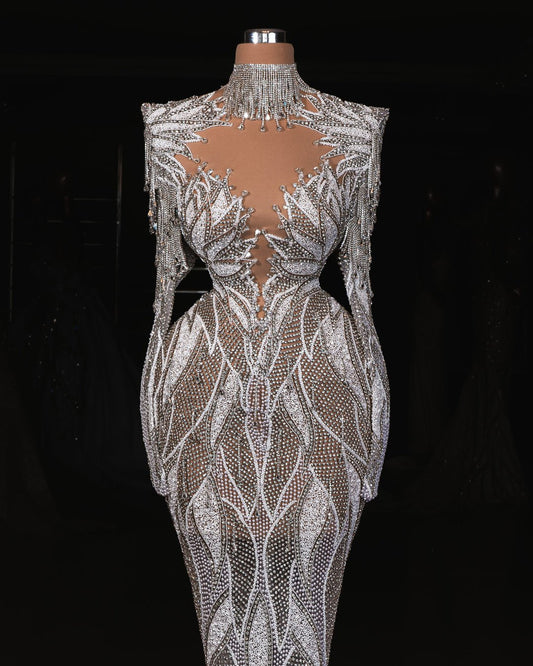 Elegant bridal gown with long sleeves and sparkling crystal details, perfect for a timeless wedding look.