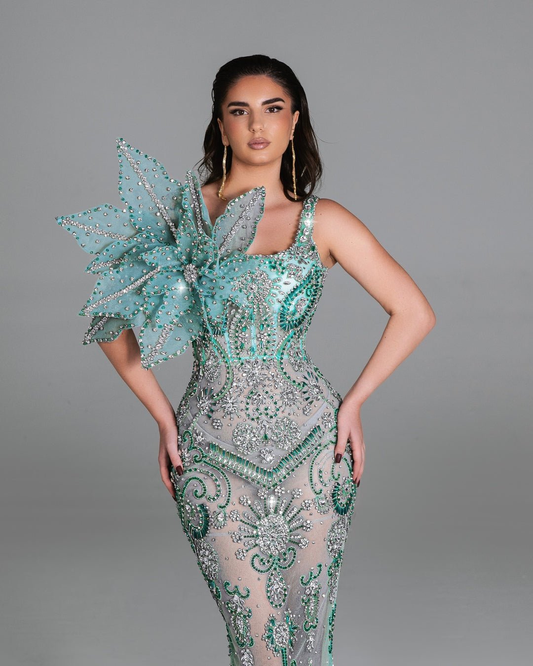 Elegant mermaid gown featuring intricate beadwork and sparkling details.
