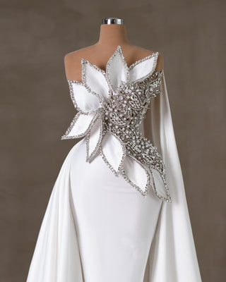 Elegant sleeveless bridal dress with intricate crystal and pearl embellishments.