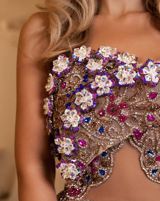 Close-up of intricate crystal embellishments on a lace gown.