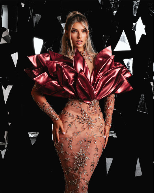 Luxurious couture gown adorned with metallic leather leaf designs and opulent stone detailing