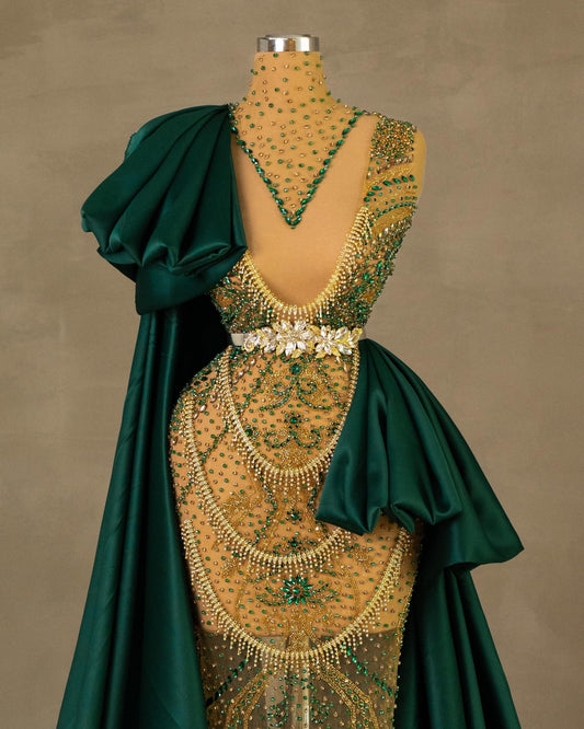 Detailed View of Gold Gown with Flowing Green Cape and Tail