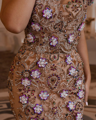 Close-up detail of intricate crystal embellishments on a sleeveless dress.
