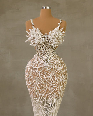 Elegant Bridal Gown Featuring Thin Straps, Stones, and Pearls