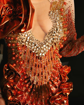 Close-up Detail of Sparkling Crystal and Bead Embellishments on Orange Dress