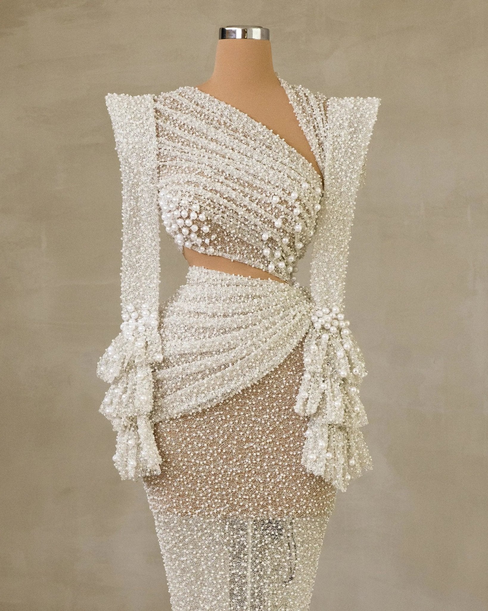 Elegant Bridal Gown Featuring Cut-Outs and Pearl Embellishments