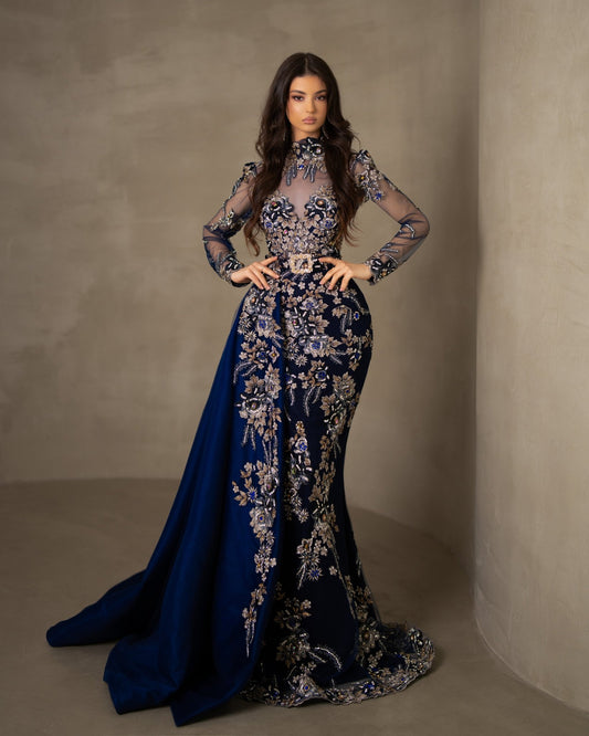 Dark blue lace dress with a high neck, long sleeves, and a flowing detachable side tail.