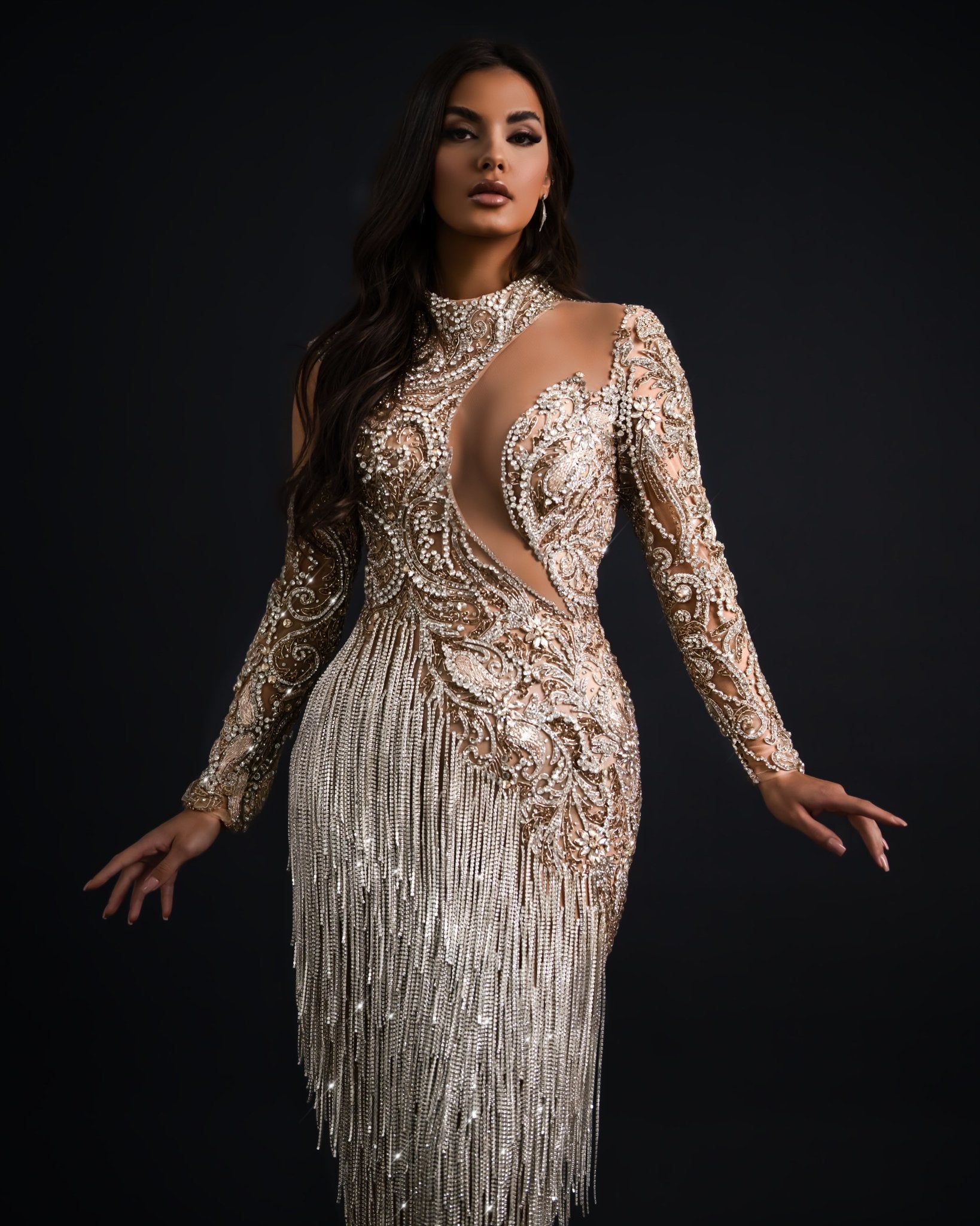 A shimmering silver tassel dress featuring intricate detailing.