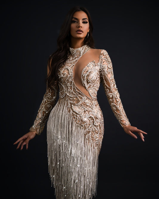 A shimmering silver tassel dress featuring intricate detailing.