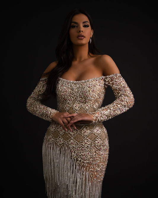 Off shoulder dress featuring intricate detailing and elegant design