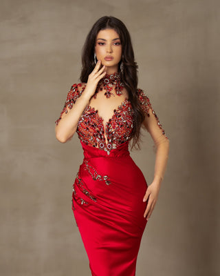 Long red dress with a luxurious lace bodice adorned with stones and crystals.