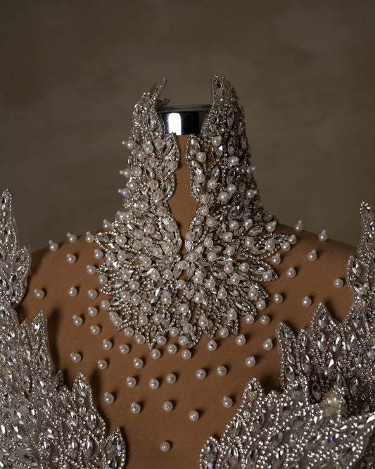 High neck adorned with crystals and pearls.