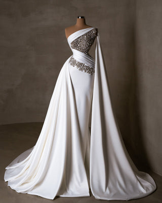 Chic bridal dress with a side tail and cape.