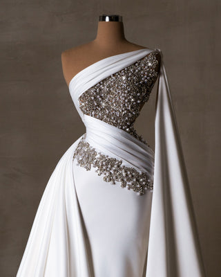 Elegant bridal dress adorned with pearls and crystals.