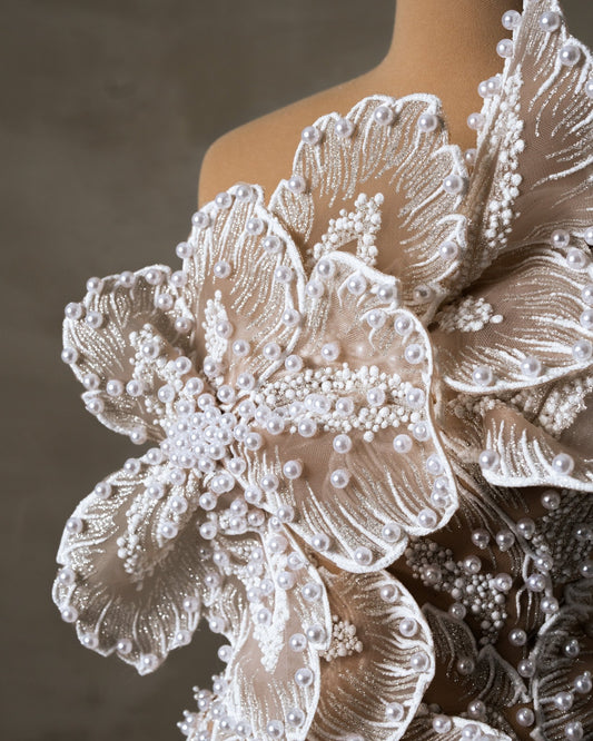 Detailed view of delicate pearls on Bridal Dress