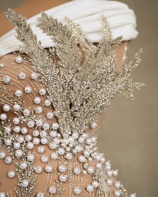 Intricate lace details adorned with pearls and crystals