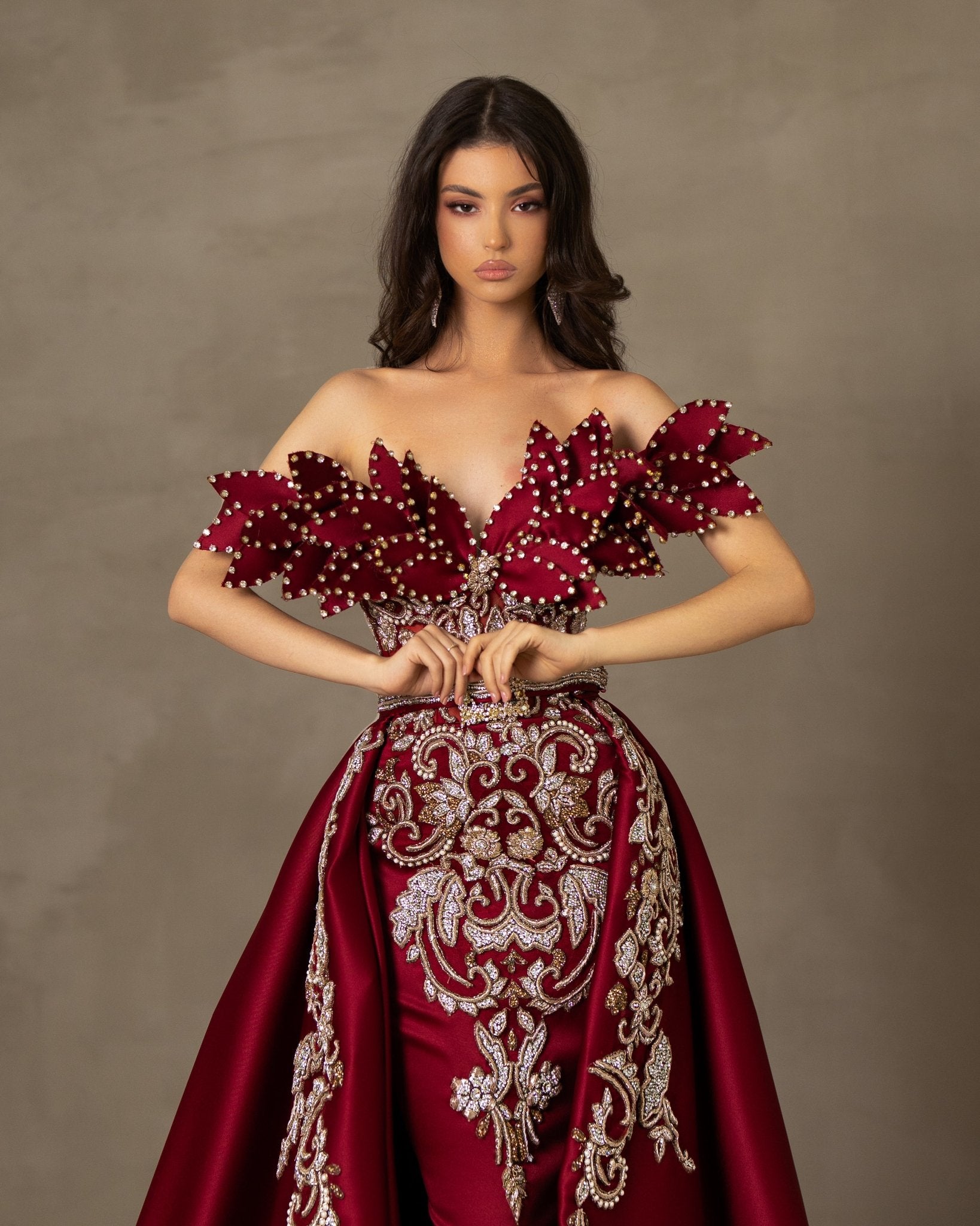 Off-shoulder dress with luxury lace detailing and stone-embellished leaf motifs.