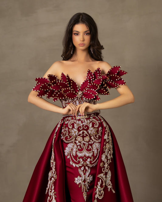 Off-shoulder dress with luxury lace detailing and stone-embellished leaf motifs.