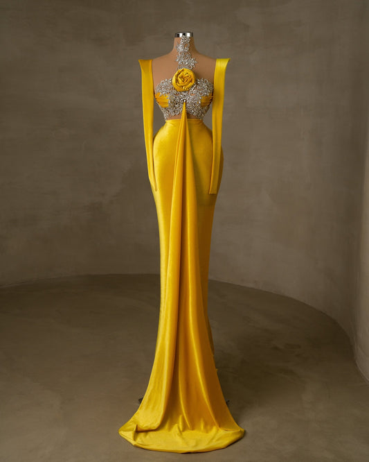 Elegant yellow velvet dress with silver detailing and floral accent.