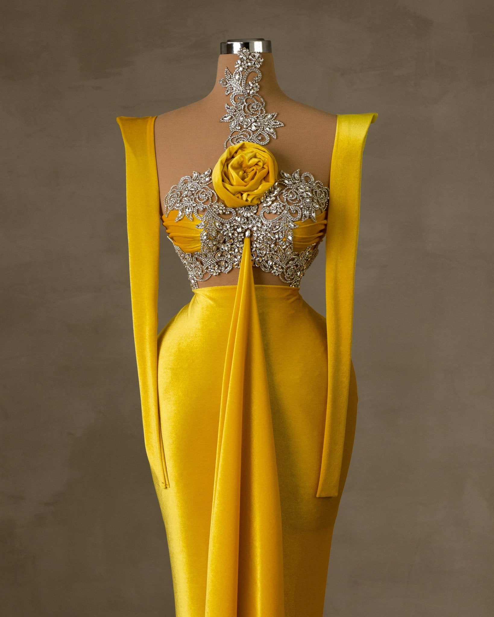 Yellow velvet dress with silver embellishments and a velvet flower.