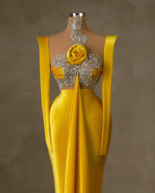 Yellow velvet dress with silver embellishments and a velvet flower.