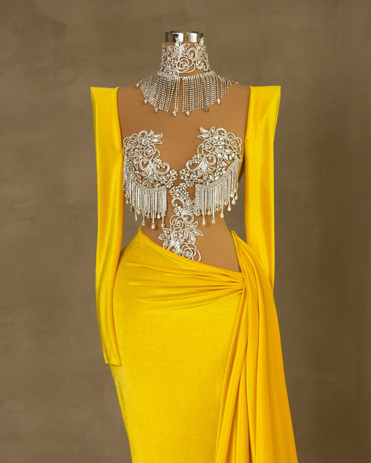 Elegant yellow velvet dress with silver embellishments.