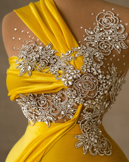 Close-up view of the bodice on a yellow velvet dress.