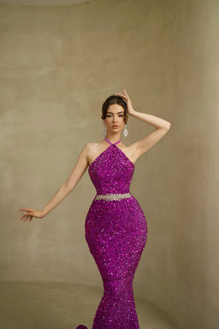 Close-up of the sparkling sequin embellishments on a purple twist neck sleeveless dress.