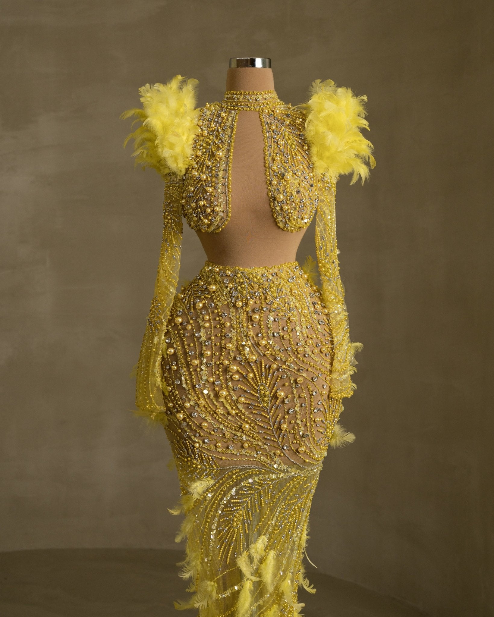 Sophisticated dress with high neckline, cut-outs, and feather accents