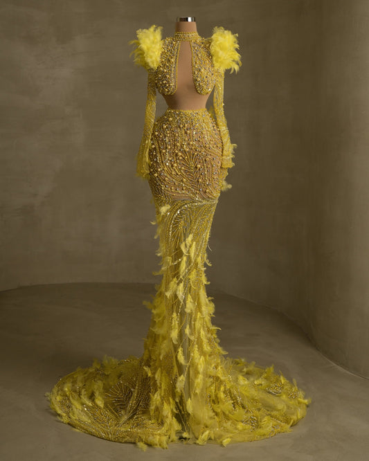 Elegant gown featuring neckline cut-outs and feather embellishments