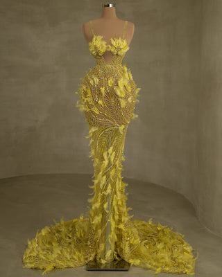 Elegant gown adorned with delicate straps, stones, and feathers