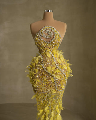 Sleeveless dress featuring exquisite feather embellishments and stoned detailing